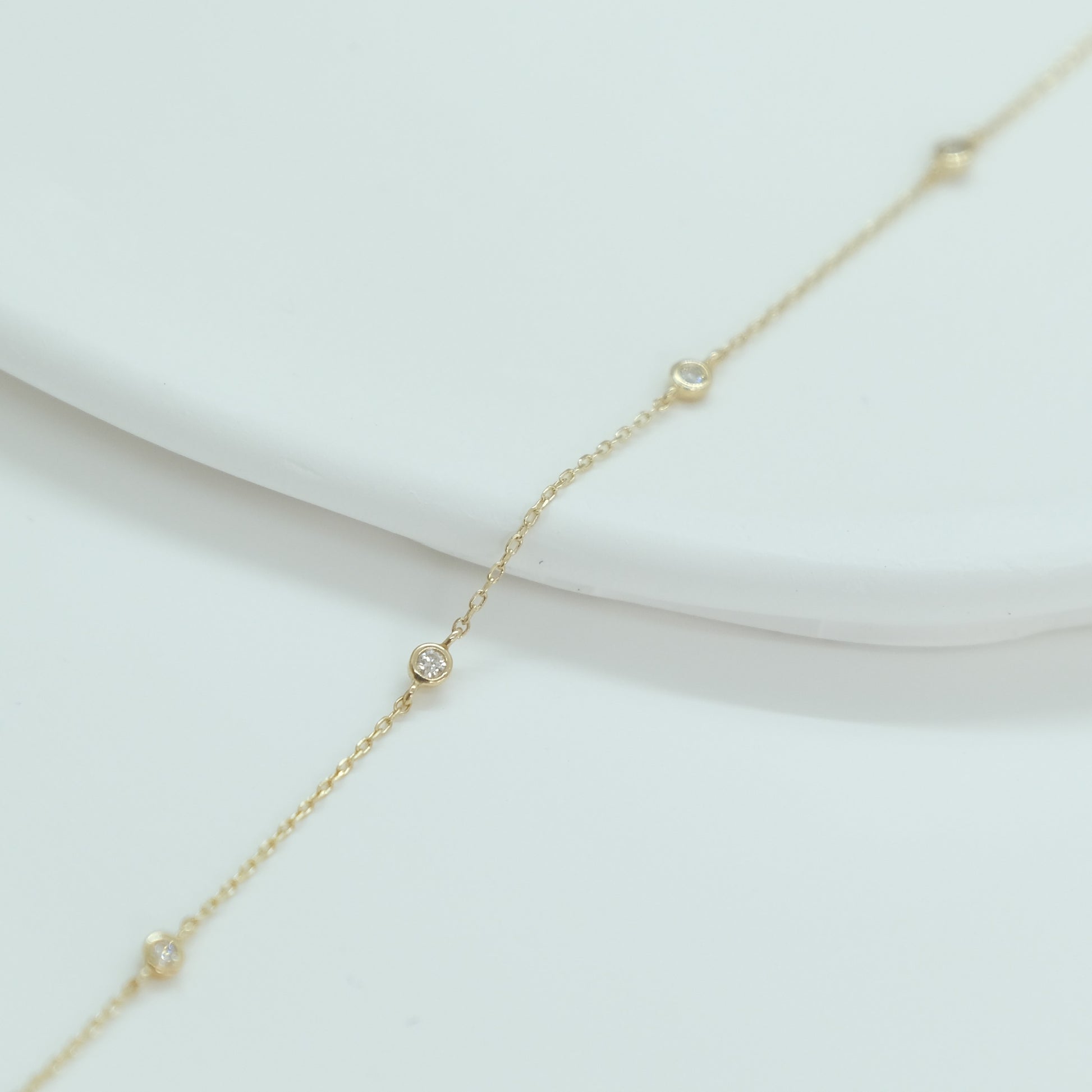 14ct recycled gold diamond bracelet on white background with pampas