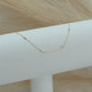 14ct recycled gold diamond on a white bracelet stand with pampas in background