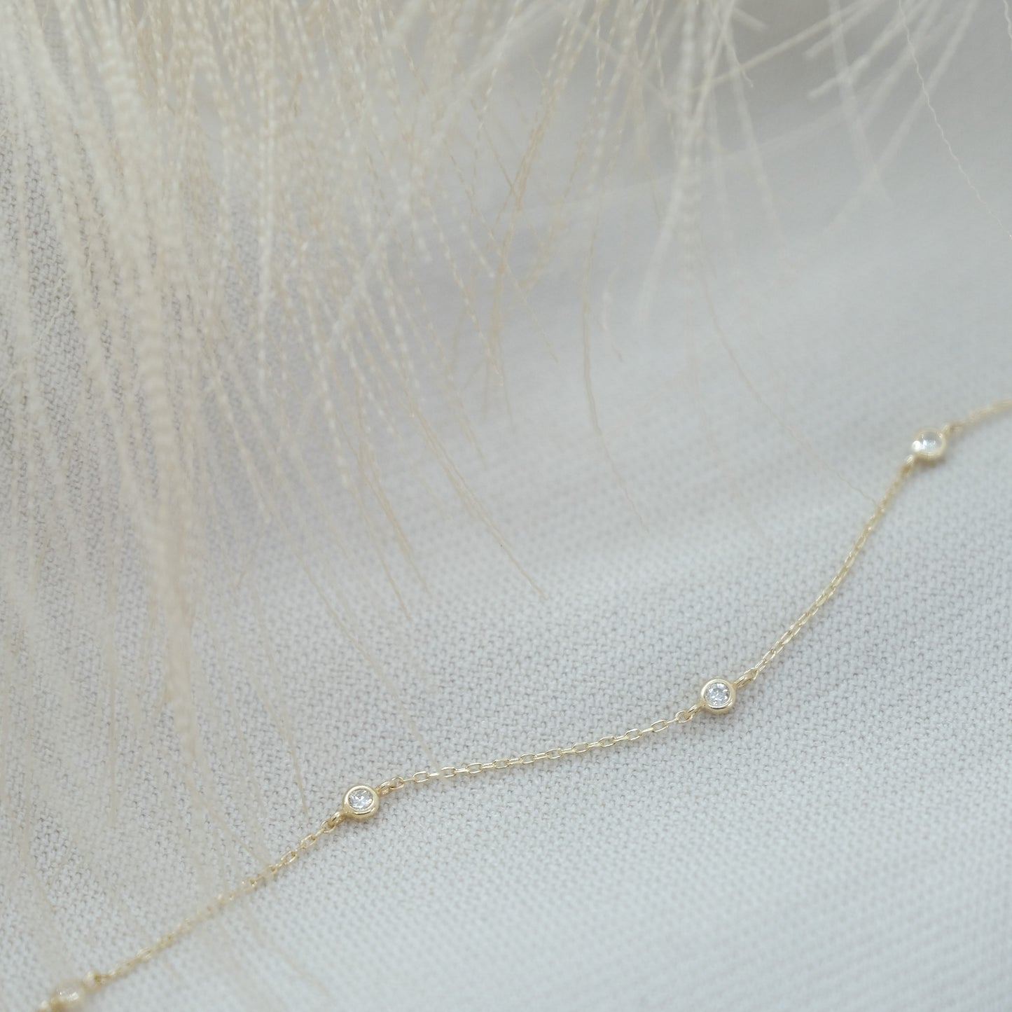 14ct recycled gold diamond bracelet on linen background
