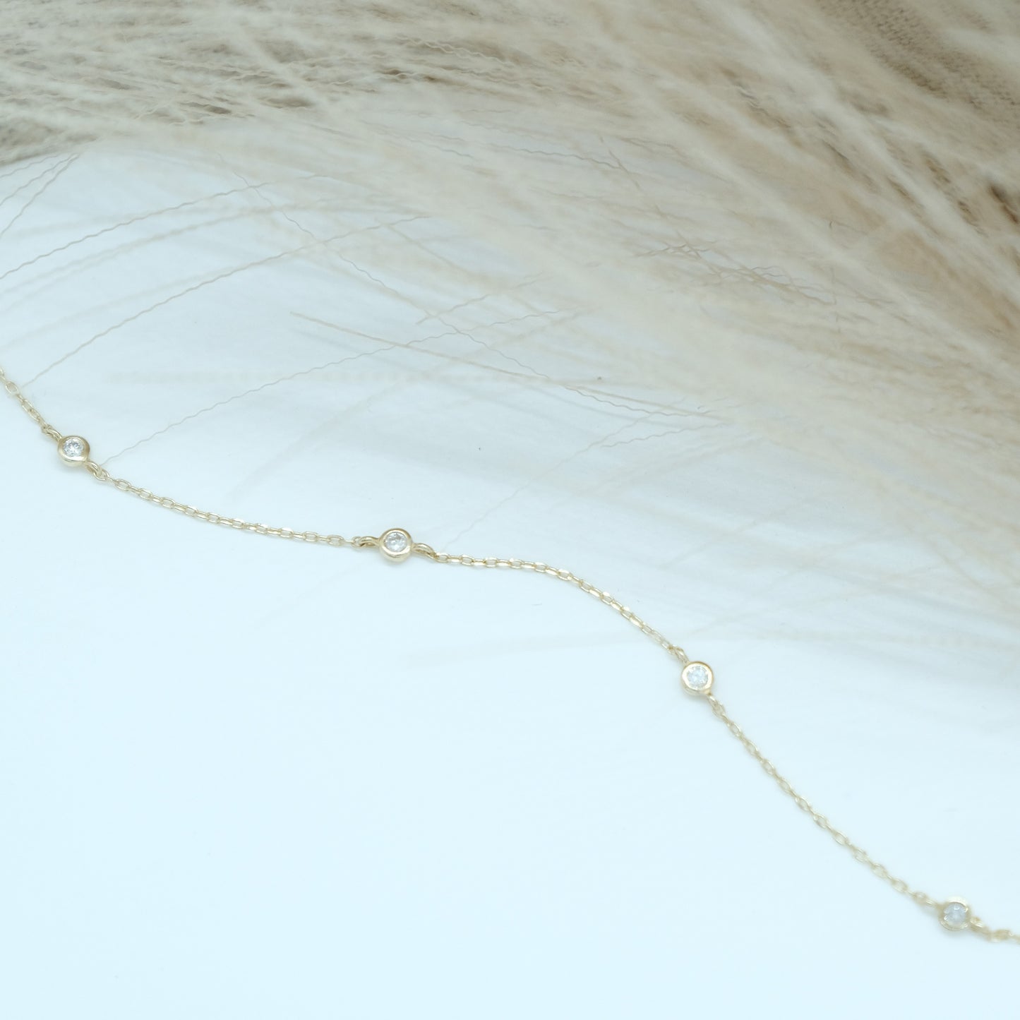14ct recycled gold diamond bracelet  on white background with pampas