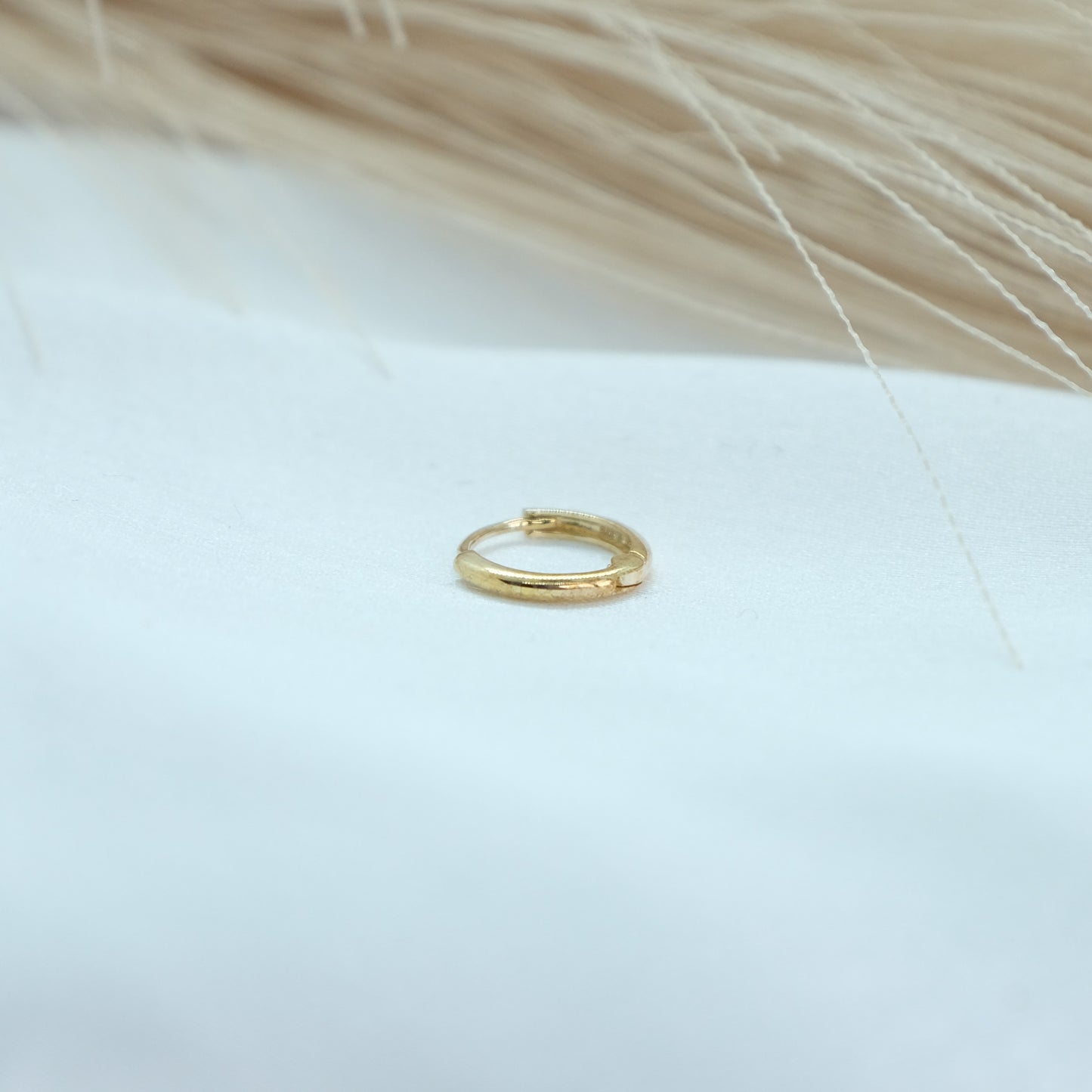 9ct Gold Classic Huggies featuring a sleek and timeless design, perfect for everyday elegance. These versatile earrings add a touch of sophistication to any outfit, suitable for both casual and formal occasions.