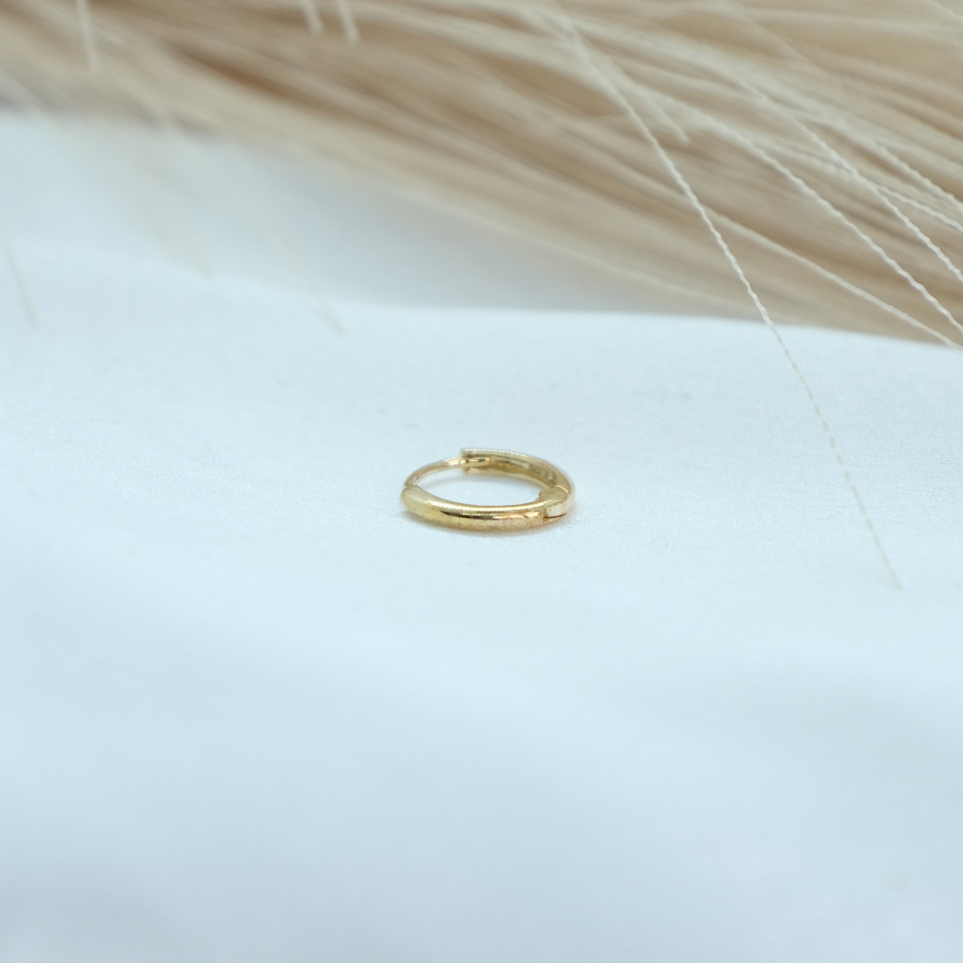 9ct Gold Classic Huggies featuring a sleek and timeless design, perfect for everyday elegance. These versatile earrings add a touch of sophistication to any outfit, suitable for both casual and formal occasions.