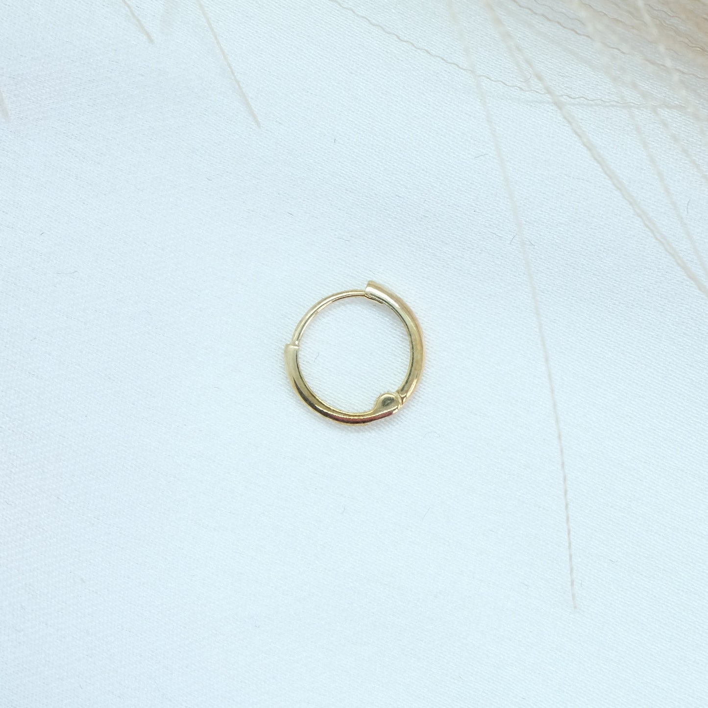 9ct Gold Classic Huggies featuring a sleek and timeless design, perfect for everyday elegance. These versatile earrings add a touch of sophistication to any outfit, suitable for both casual and formal occasions.