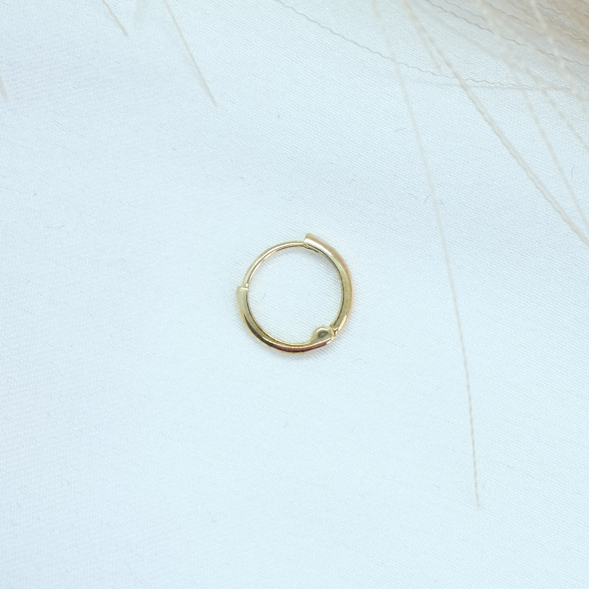 9ct Gold Classic Huggies featuring a sleek and timeless design, perfect for everyday elegance. These versatile earrings add a touch of sophistication to any outfit, suitable for both casual and formal occasions.