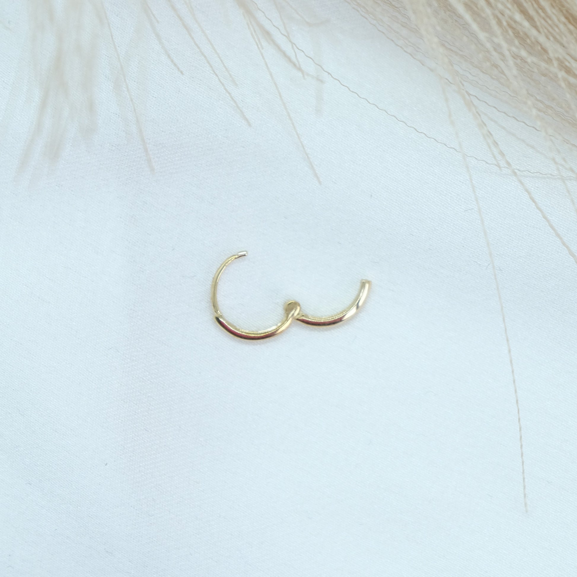 9ct Gold Classic Huggies featuring a sleek and timeless design, perfect for everyday elegance. These versatile earrings add a touch of sophistication to any outfit, suitable for both casual and formal occasions.