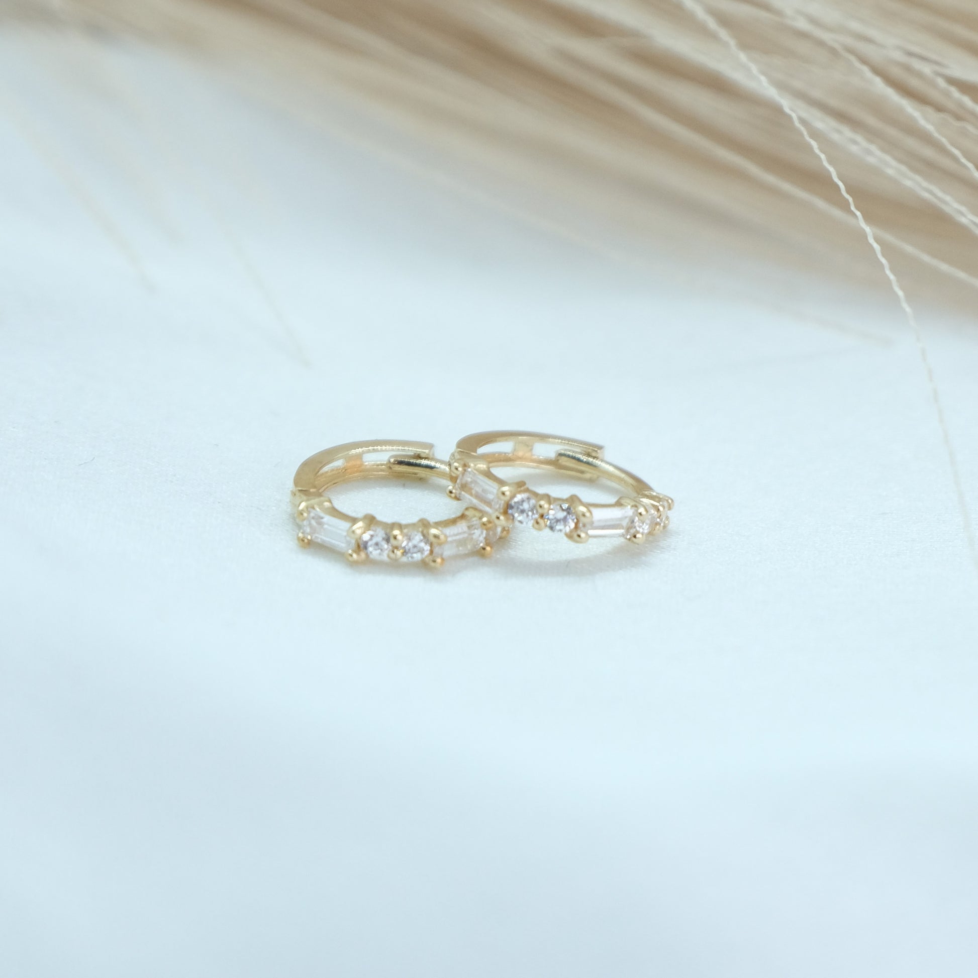 9ct Baguette Gem Huggies from Ella Ray Jewellery: Elegant, versatile huggie earrings crafted from 9ct gold with sparkling baguette-cut gems in a variety of colors, perfect for everyday glamour.